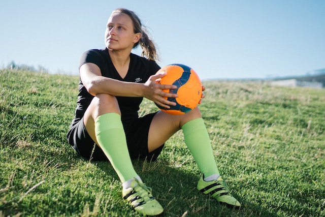 Donna calciatrice seduta- Come diventare allenatore di calcio